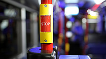 Close up stop button in a bus, background pre-swim.