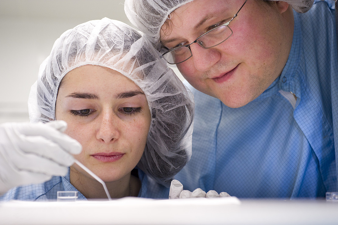 Two researchers with hoods. 